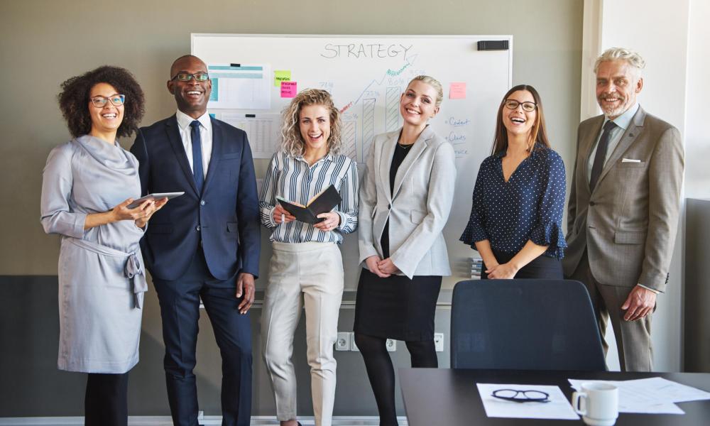 Team of business people looking at camera Team of business people looking at camera smiling and laughing, mixed races entrepreneurs with positive emotions